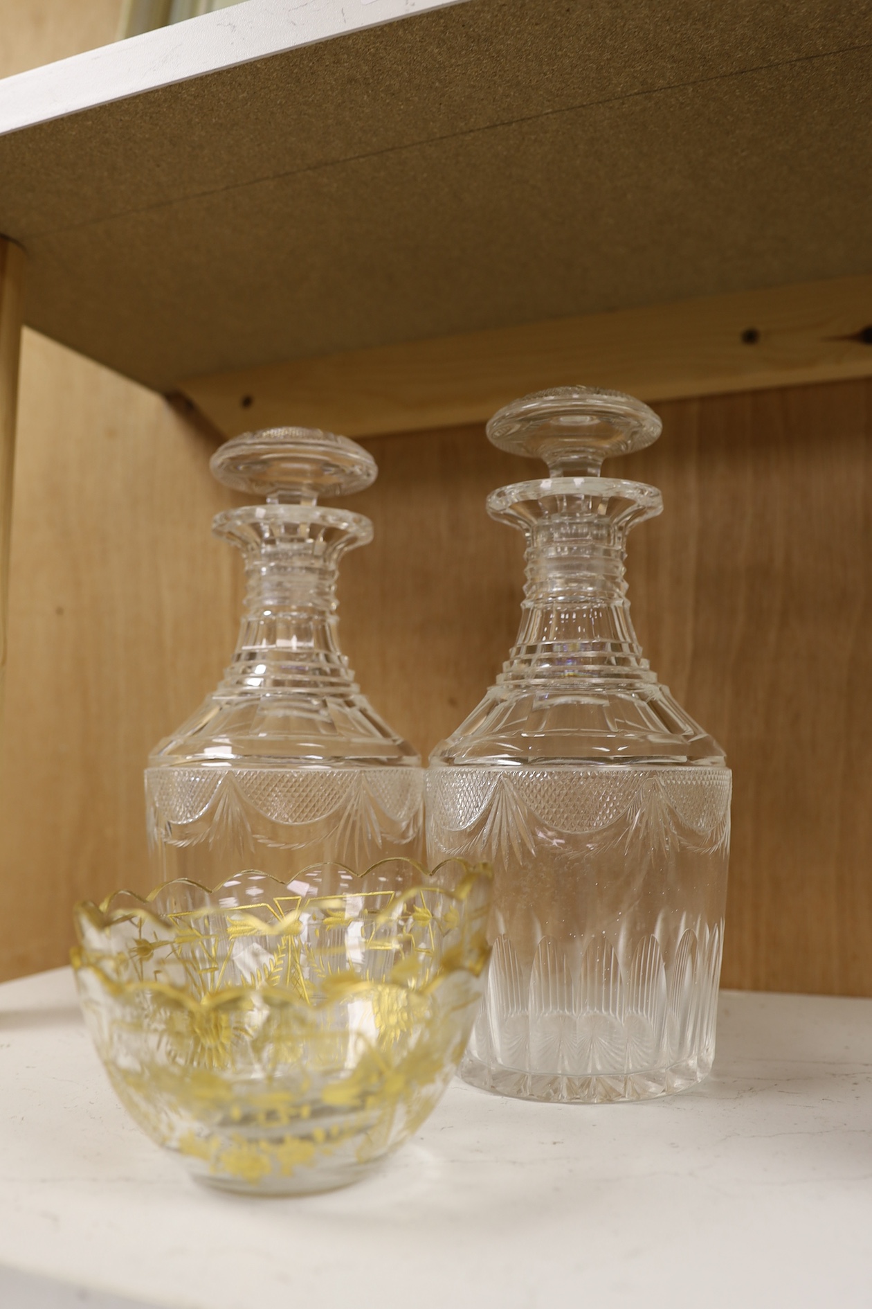 A pair of Regency decanters and stoppers and a pair of gilded glass finger bowls, decanters and stoppers 25.5cm high. Condition - good